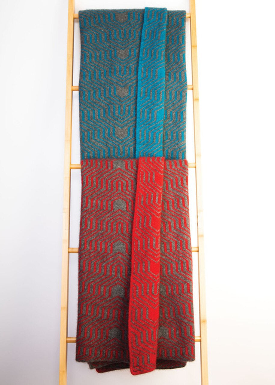 Two Koru Merino and Possum Patterned Throws draped over wooden ladder.