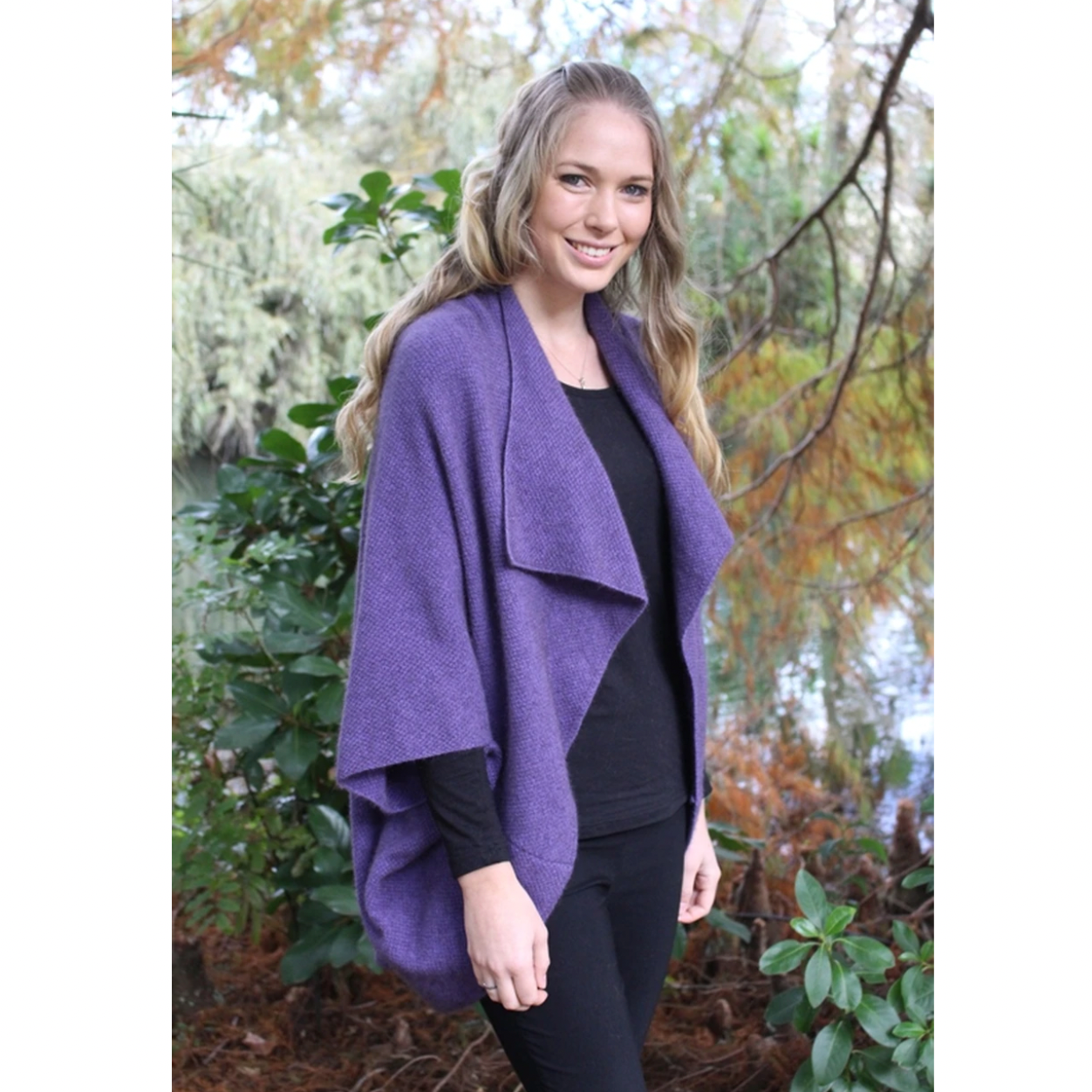 Woman wearing Takahe cape in colour Heather