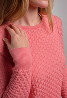 Close up of woman wearing Country Laine - Merino Basketweave Jumper (CL0057) in the colour Peach.