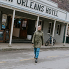 Woman wearing Moke - Sydney Cloud Touch 90/10 Down Coat (SYDNEY) in the colour Black while walking down a street.