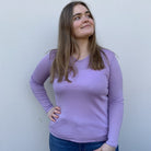 Woman wearing vee neck top in colour Taffetta