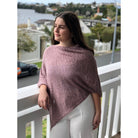 Woman wearing cotton poncho. Colour Orchid