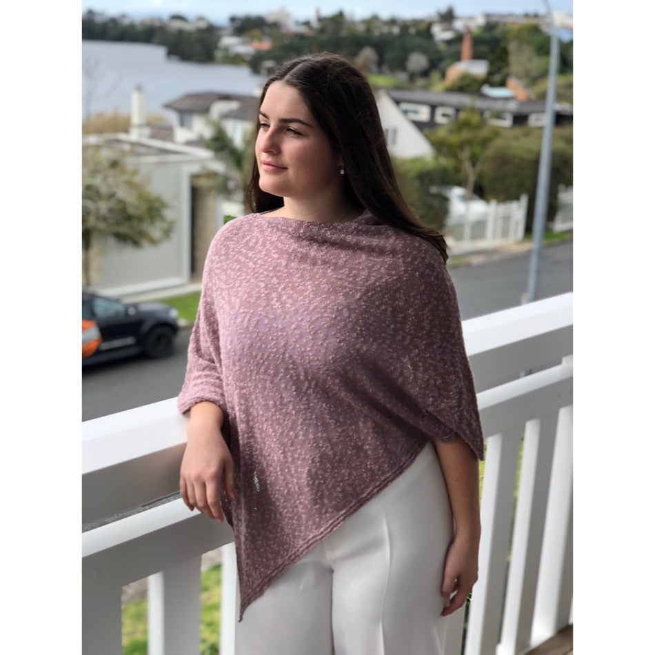 Woman wearing cotton poncho. Colour Orchid