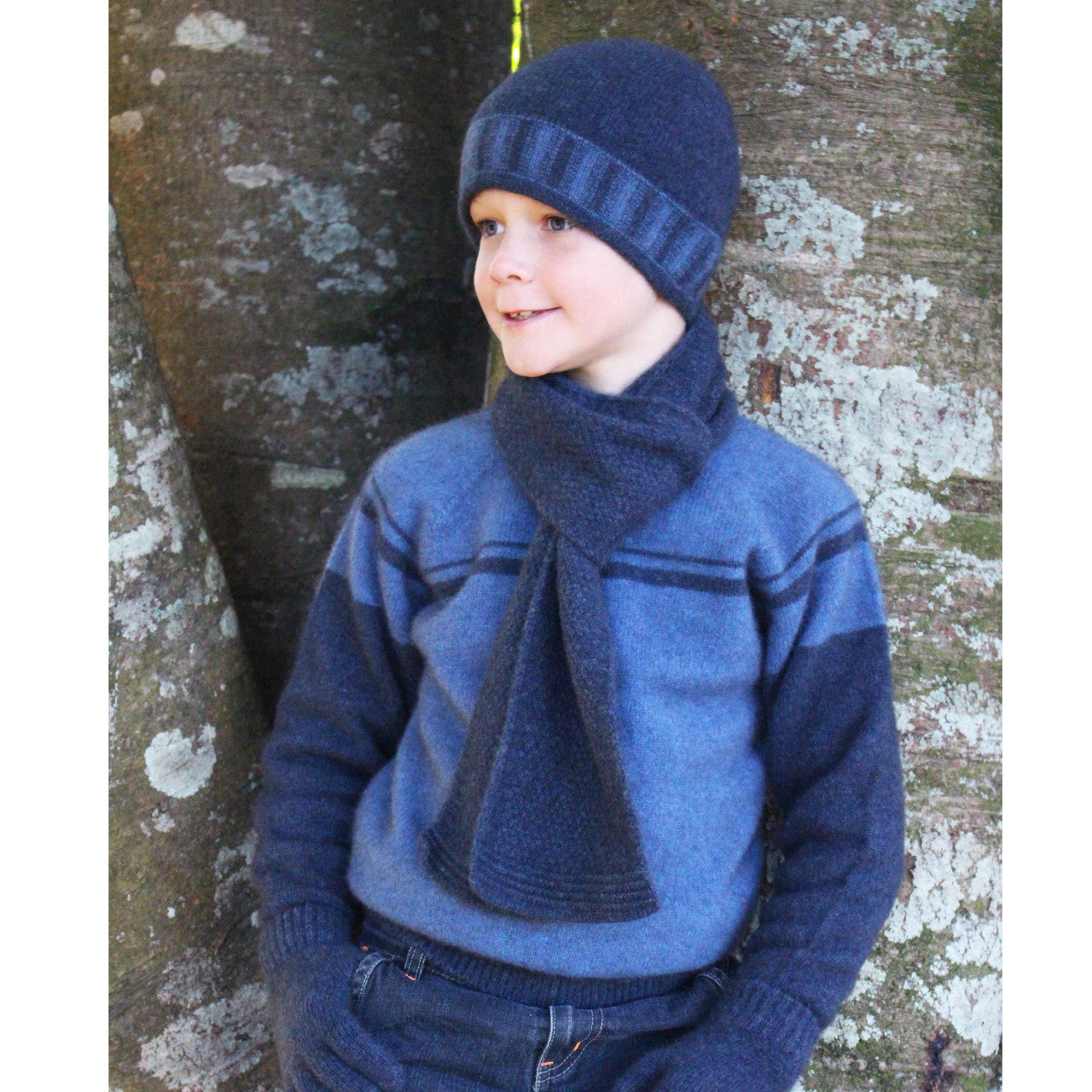 Boy facing right wearing Denim colour jumper.
