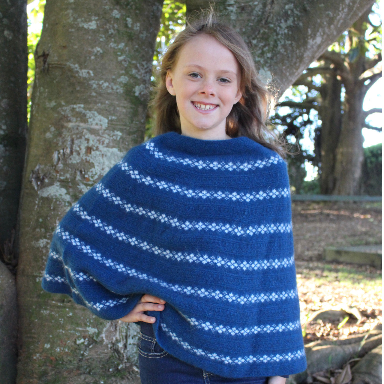 Girl wearing Poncho in colour lagoon.