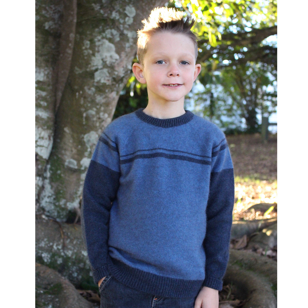 Boy facing straight wearing Denim colour jumper.
