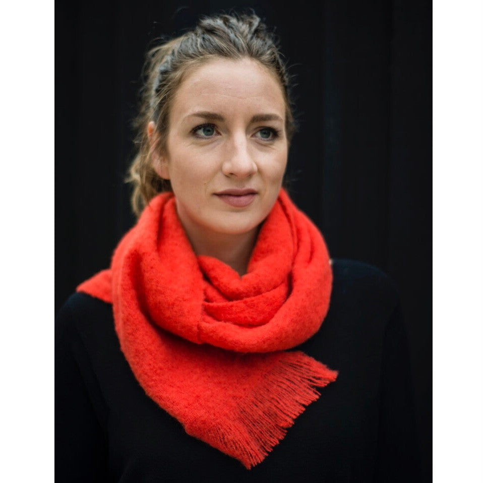Model wearing Alpaca scarf in colour Hibiscus