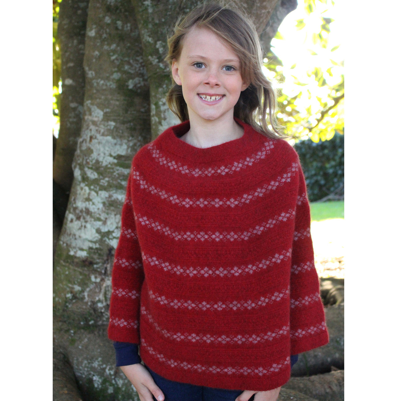 Girl wearing Poncho in colour red.