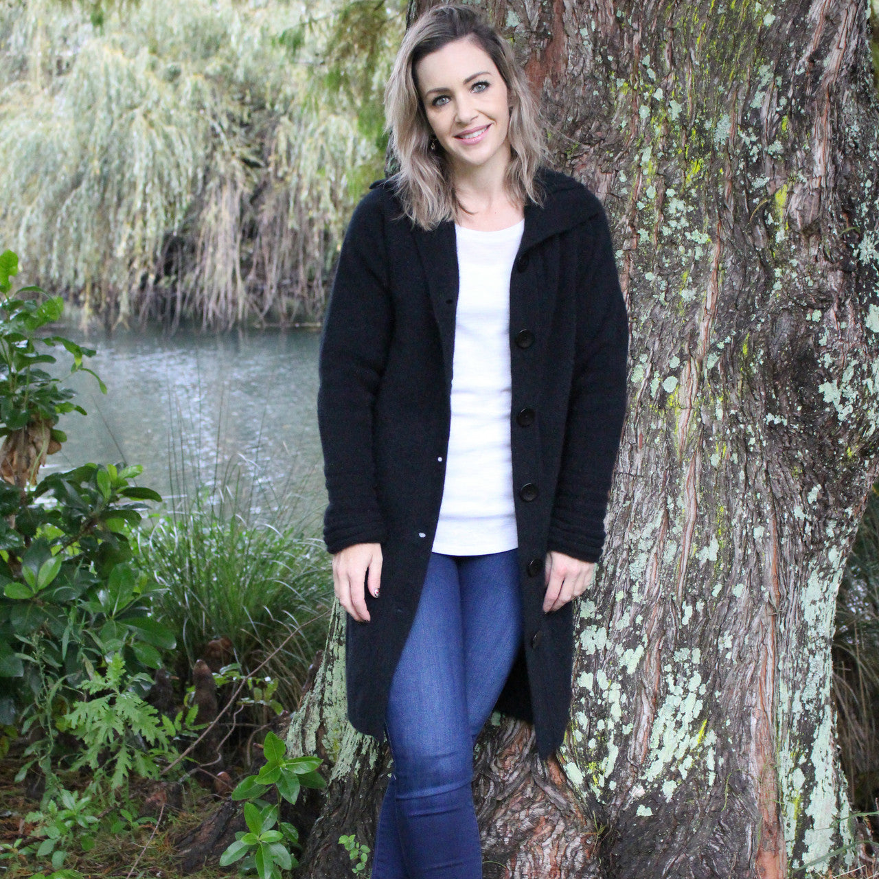Woman wearing Possum Long coat in black.