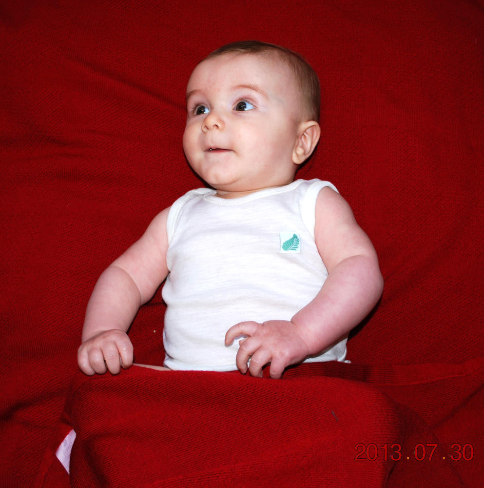 Merino wool baby’s singlet in Winter White colour.
