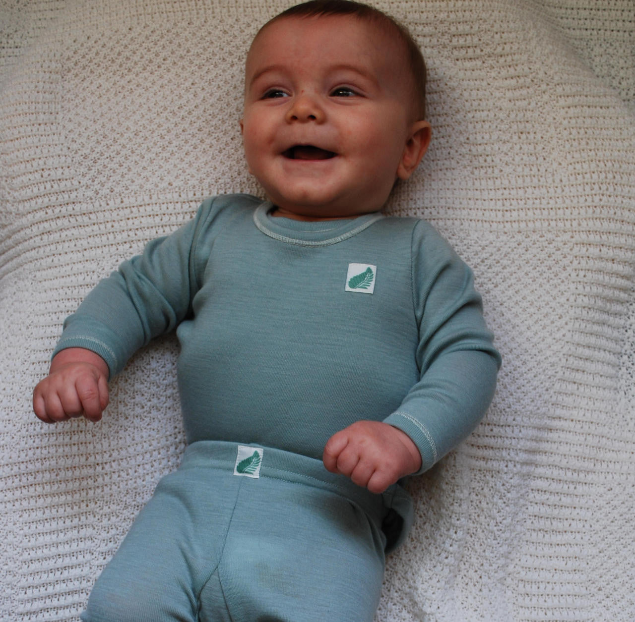 Merino wool long sleeved babies top in teal.