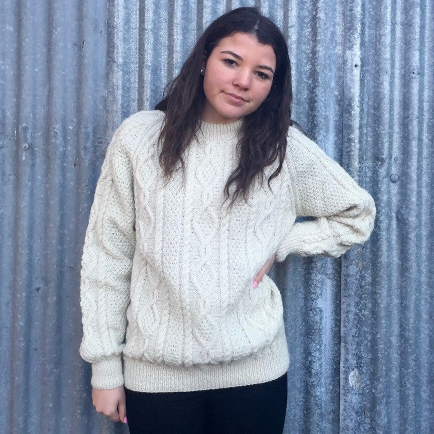 Woman wearing Lesley Unisex Aran Wool sweater in the colour Cream.
