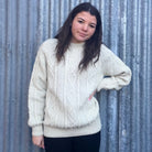 Woman wearing Lesley Unisex Aran Wool sweater in the colour Cream.